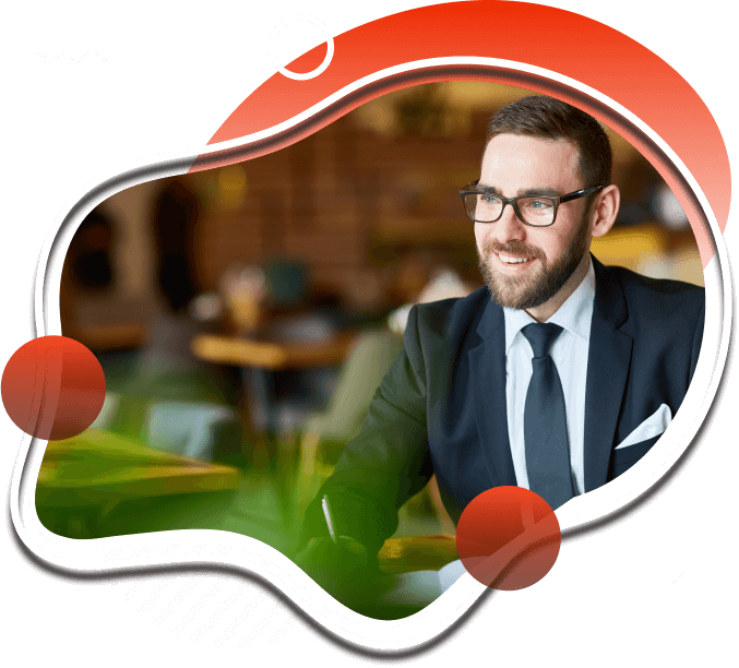 Smiling man in a suit and glasses sitting indoors, modern abstract design border